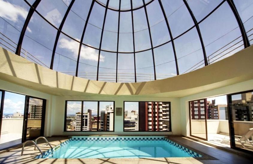 durante o dia, piscina em área de lazer coberta com vista para a cidade em Radisson Hotel Curitiba