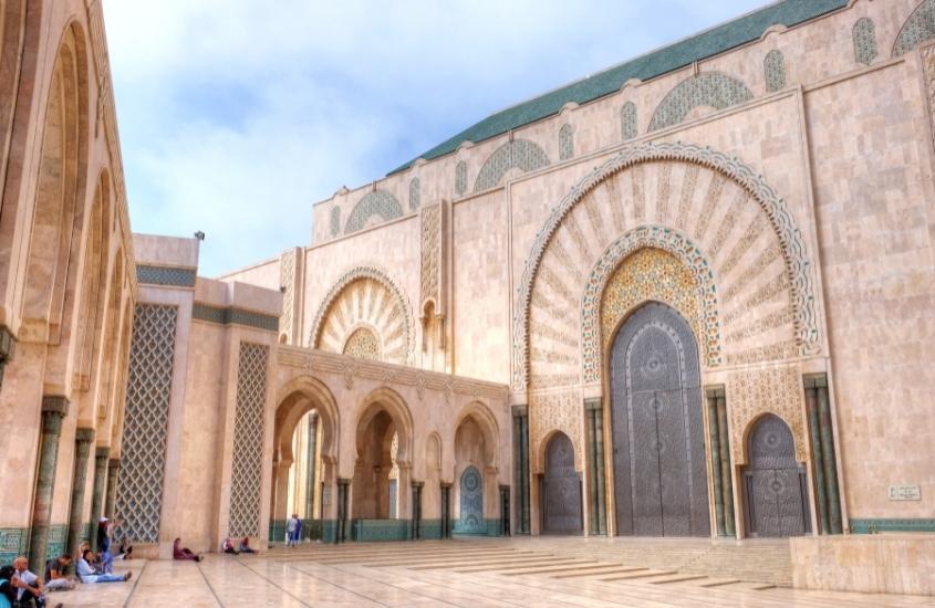 edifício de concredto, cor de areia com detalhes verdes, durante o dia em casablanca, destino para um roteiro marrocos