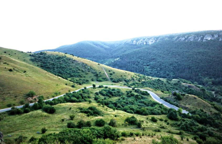 durante o dia, vista aérea de montanhas verdes em reserva natural, atração para quem busca o que conhecer na romênia