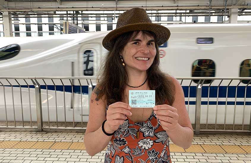 Bárbara Rocha Alcantelado com o JR Pass em frente ao trem bala no Japão