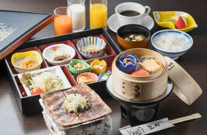 sucos, café e frutas em cima de mesa de madeira em um dos melhores hotéis no japão