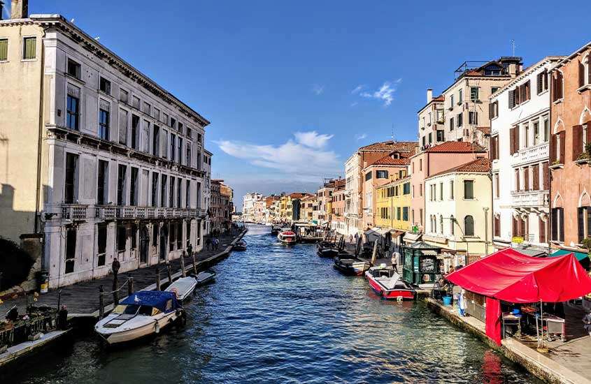 Durante um dia ensolarado, prédios pitorescos às margens de um dos canais de Veneza, em Cannaregio, um lugar onde se hospedar em veneza.