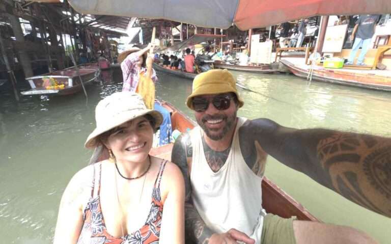 Em um dia de sol, Bárbara Rocha Alcantelado e Vagner Alcantelado em um barco em mercado flutuante da Tailândia