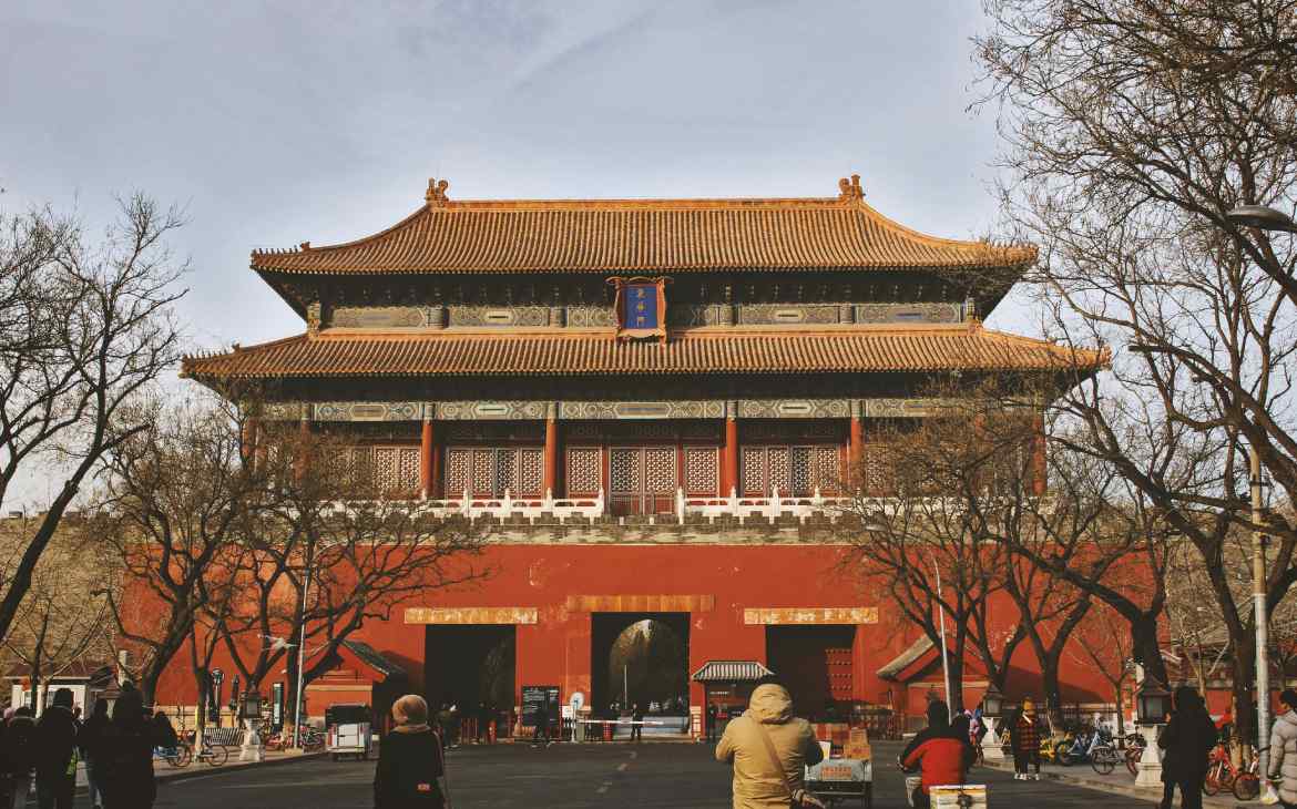 Em um dia de sol, castelo imperial chinês com árvores e pessoas ao redor