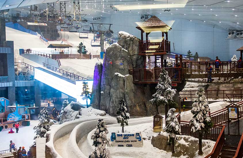 Uma paisagem coberta de neve artificial dentro de uma enorme estação de esqui fechada, em pleno Oriente Médio.