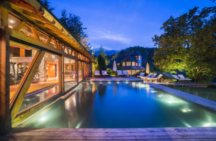 Piscina iluminada ao anoitecer no Las Balsas Relais, um dos melhores resorts de inverno na Argentina