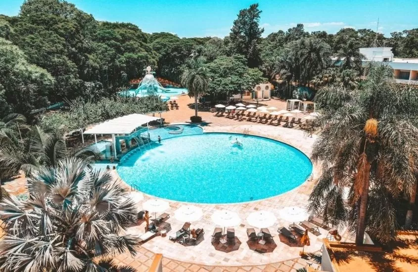 vista aérea de piscina cercada de arvores em Bourbon Cataratas do Iguaçu Resort, um ótimo lugar para se hospedar em uma lua de mel no brasil