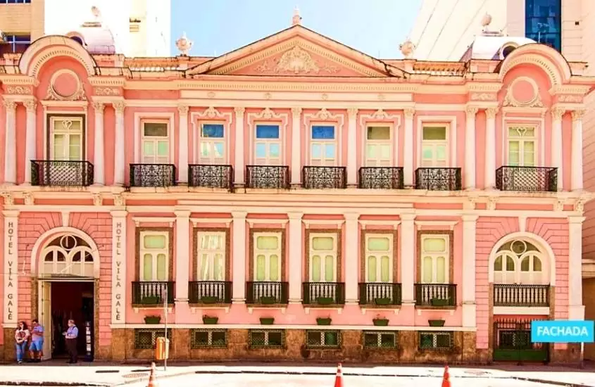 durante o dia, palácio rosa de dois andares onde funciona hotel histórico no rio de janeiro